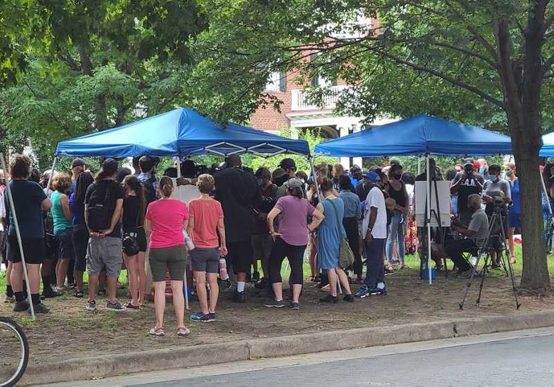 Crowds Gather Under Tents To Discuss Policy With Elected Officials