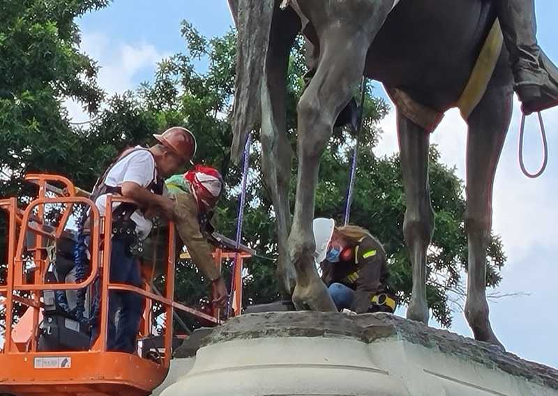 Workers inspect Stonewall Jackson confederate statue as they prepare for removal