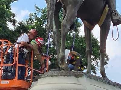 Workers inspect Stonewall Jackson confederate statue as they prepare for removal